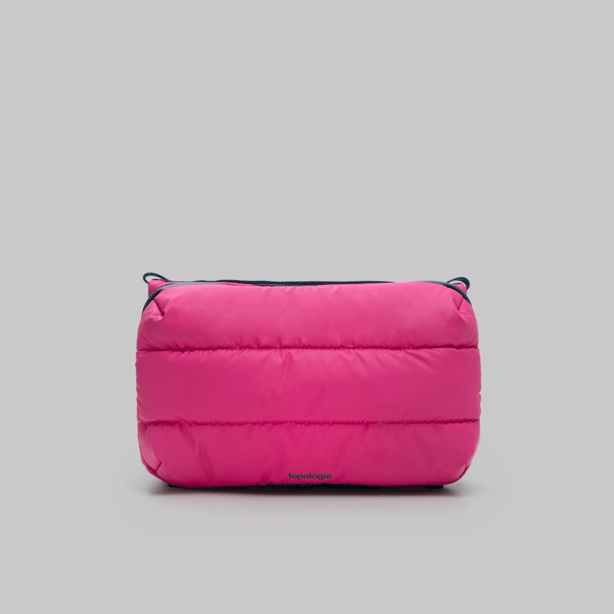 Large puffy pink bottle bag from topologie on a gray background