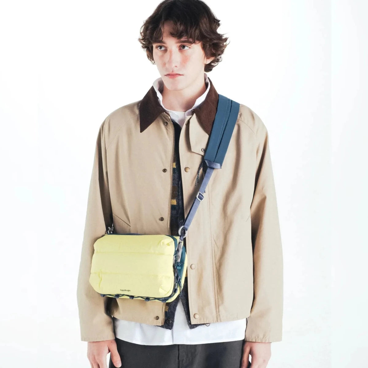 Large Puffy Bottle Sacoche by Topologie featuring a soft, padded design in vibrant fabric with a zipper closure and adjustable strap.