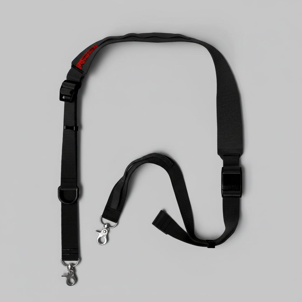 Wide utility sling strap by Topologie shown in black, designed for secure and comfortable carrying of bags or gear.
