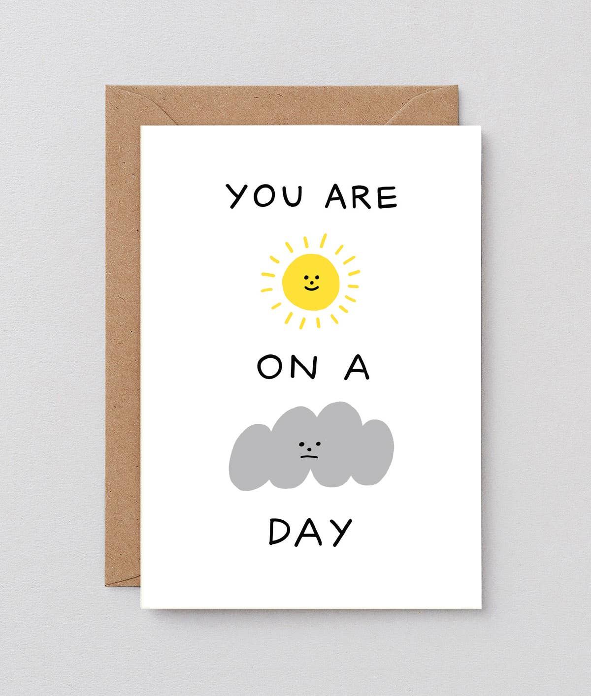 Brightly illustrated "Sunshine On A Cloudy Day" greetings card by Wrap featuring cheerful cloud and sun design.