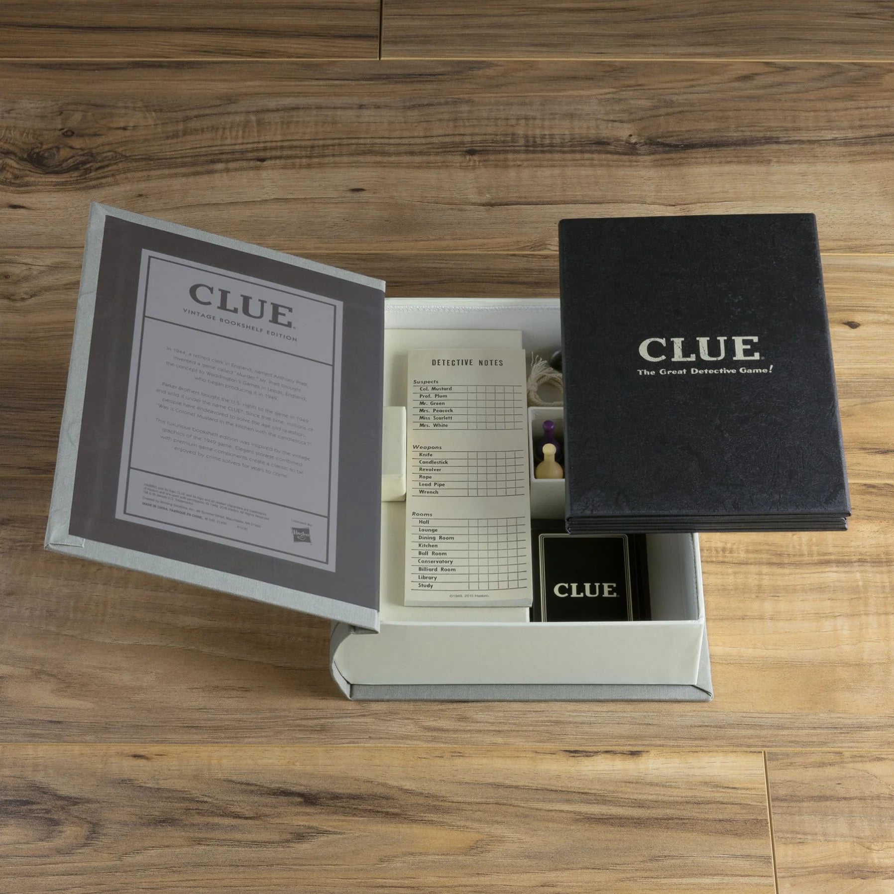 Clue board game vintage bookshelf edition by WS Game Company, featuring classic artwork and game components on a decorative bookshelf-themed box.