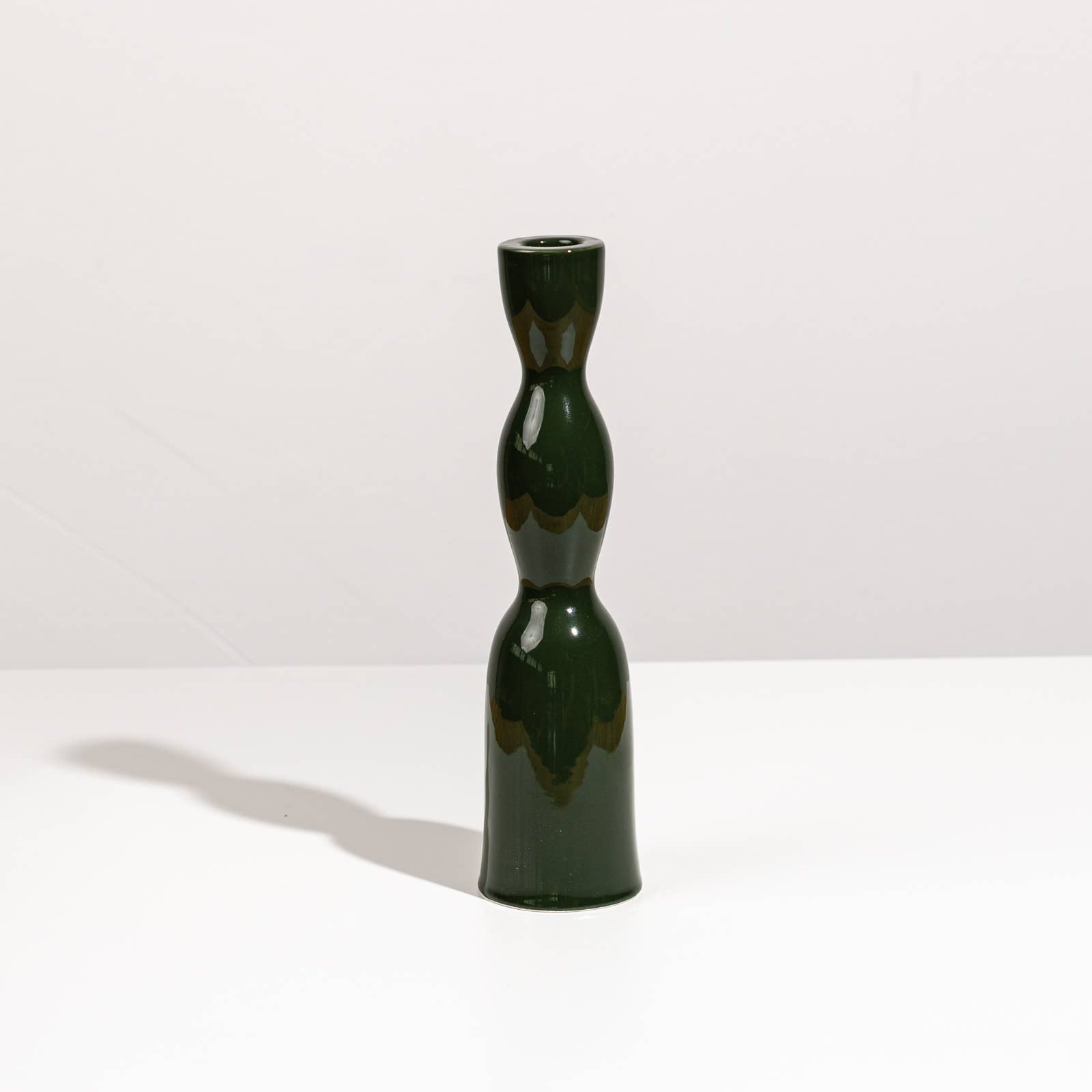 Tall dark green Wave Candleholder by YOD&CO featuring a sleek, modern design perfect for decorative candle display.