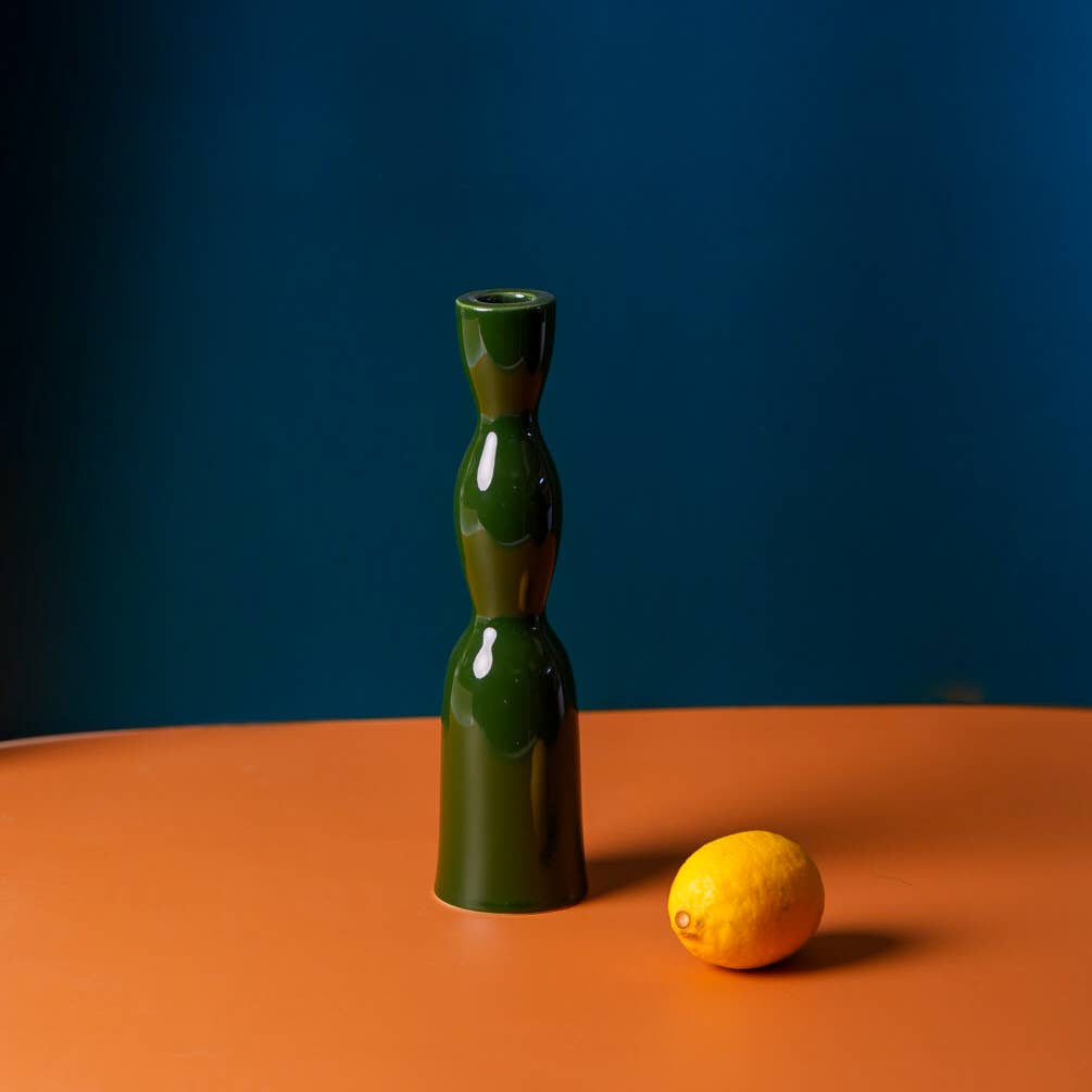 Tall dark green wave-shaped candleholder by YOD&CO with a sleek, modern design perfect for decorative candles.