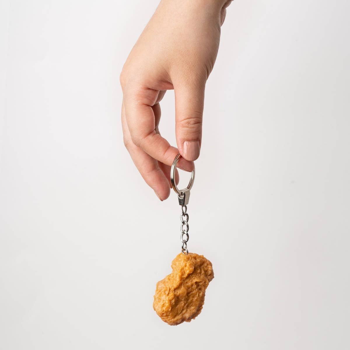 Yumazing Chicken Nugget keychain accessory with a realistic fried chicken nugget design, attached to a metal keyring.