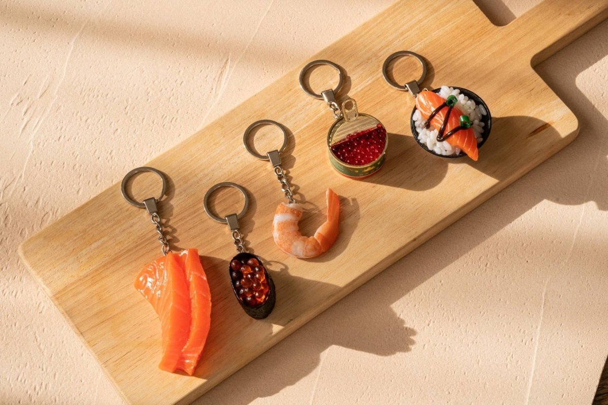 Ikura sushi keychain from Yumazing, featuring a realistic orange salmon roe design on a small keychain.
