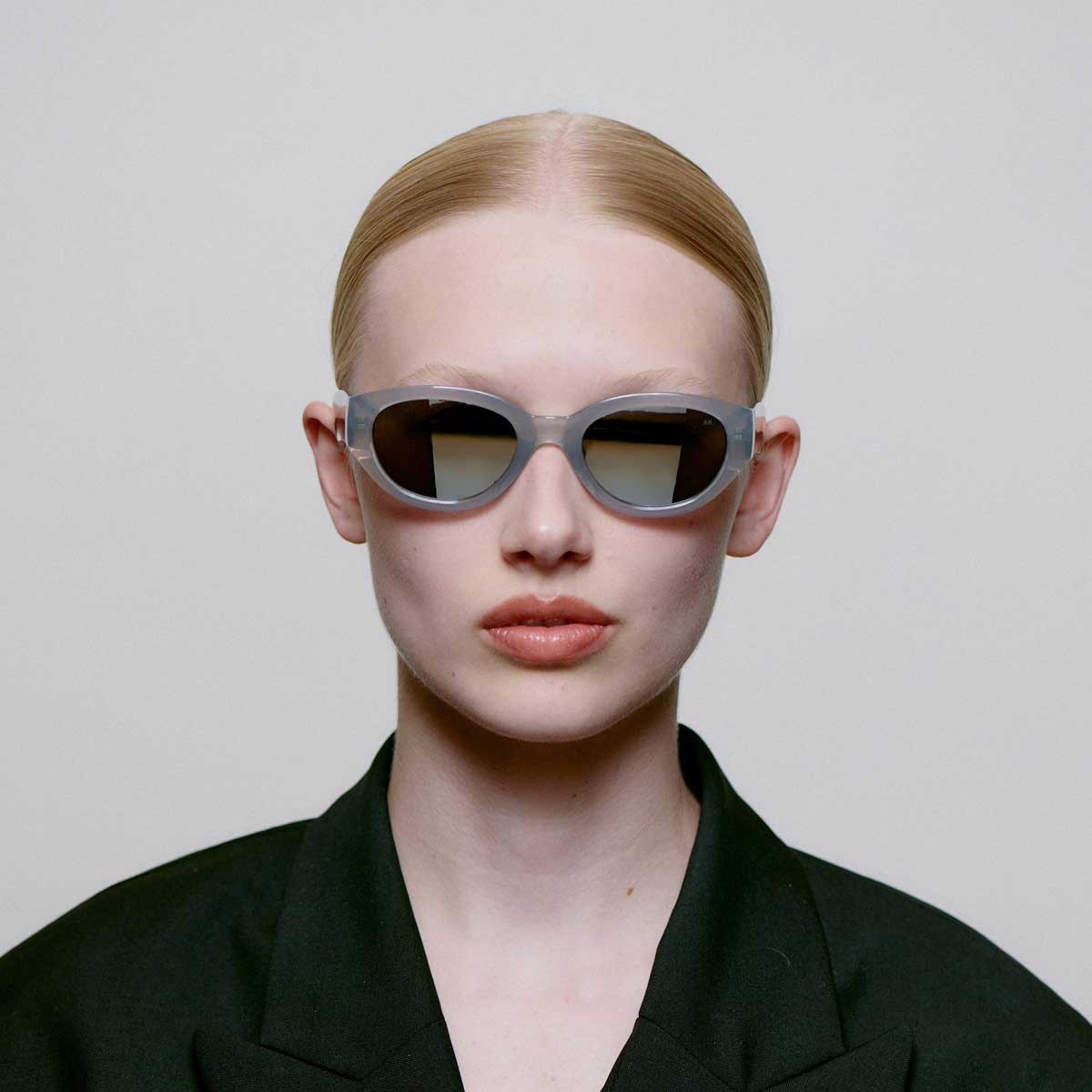 A. Kjaerbede Winnie sunglasses with round frames and dark tinted lenses, stylish eyewear for sun protection.